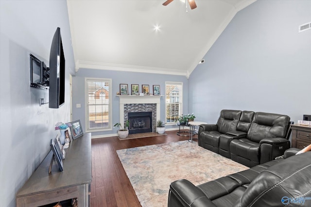 living room with crown molding, ceiling fan, dark hardwood / wood-style floors, a fireplace, and vaulted ceiling