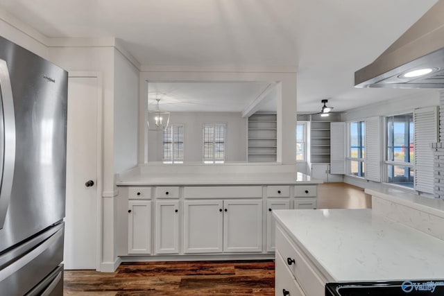 kitchen featuring ceiling fan with notable chandelier, white cabinetry, dark wood-style flooring, and freestanding refrigerator