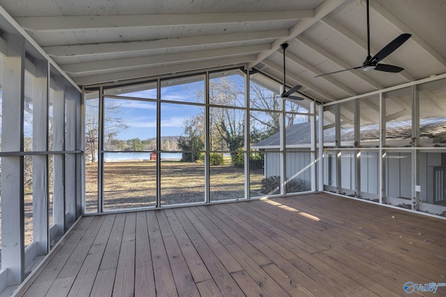 unfurnished sunroom featuring vaulted ceiling, a water view, ceiling fan, and a healthy amount of sunlight