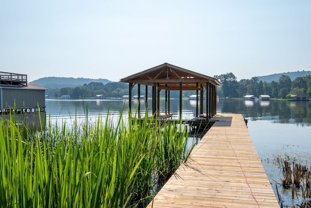 view of dock featuring a water and mountain view