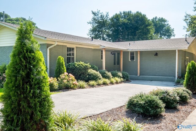 view of front of home with a front lawn and a water view