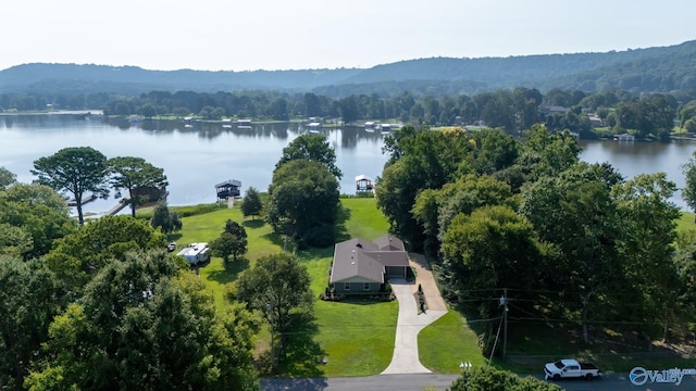 drone / aerial view featuring a water view and a forest view