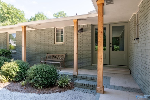 doorway to property with crawl space and brick siding