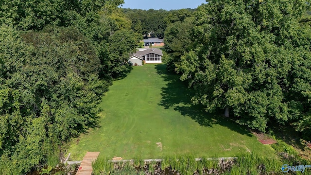 birds eye view of property featuring a view of trees