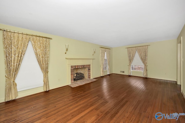 unfurnished living room with a fireplace and wood-type flooring