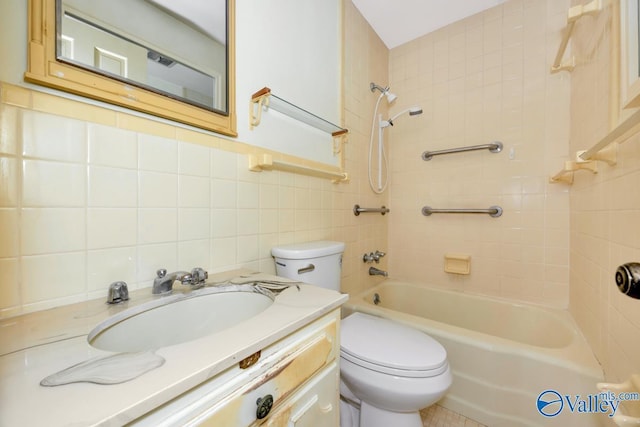 full bathroom featuring vanity, backsplash, tiled shower / bath combo, toilet, and tile walls