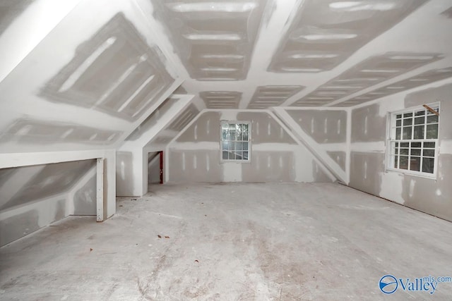 additional living space featuring lofted ceiling