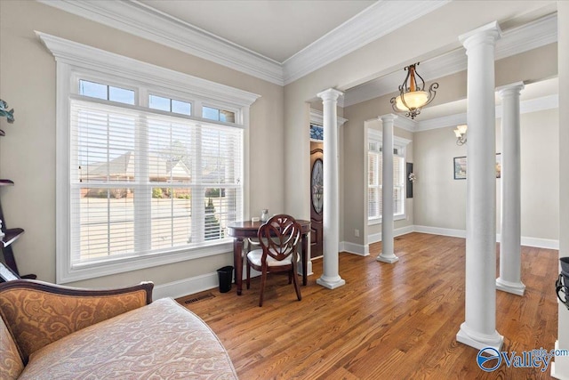 sitting room featuring ornate columns, visible vents, ornamental molding, and light wood-style floors