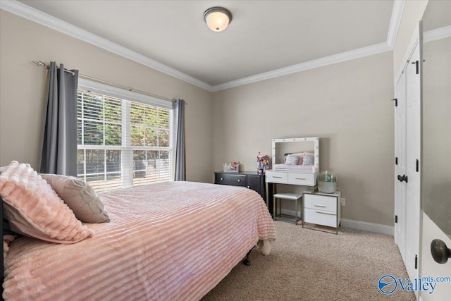 bedroom with carpet flooring, crown molding, and baseboards