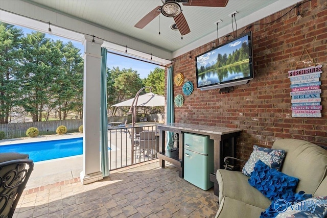 exterior space with a fenced in pool, fence, and ceiling fan