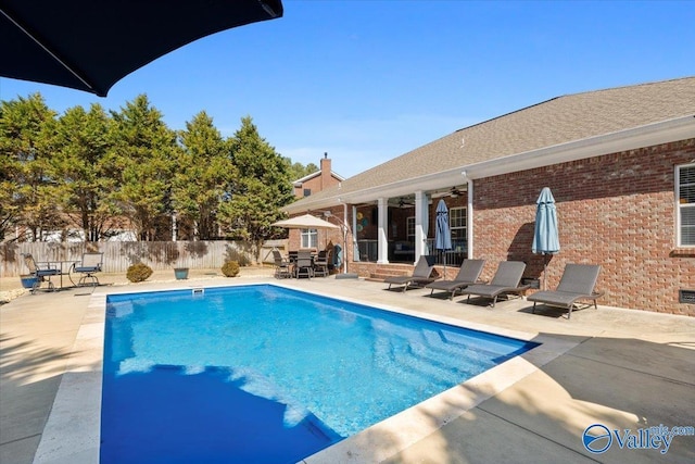 view of swimming pool featuring a fenced in pool, a patio area, ceiling fan, and a fenced backyard