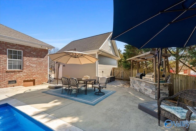 view of patio / terrace featuring a grill, fence, outdoor dining area, and area for grilling