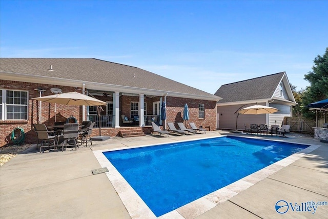 view of swimming pool featuring outdoor dining space, fence, a ceiling fan, and a patio