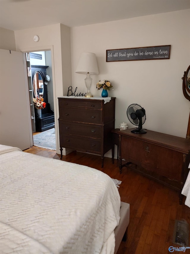 bedroom with dark hardwood / wood-style floors