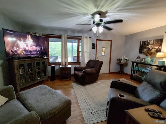 living room with light wood-type flooring and ceiling fan