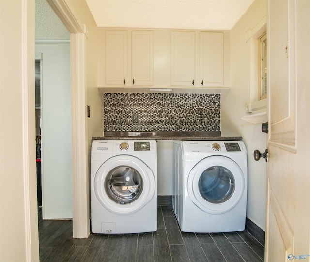 washroom with cabinets, separate washer and dryer, and a textured ceiling