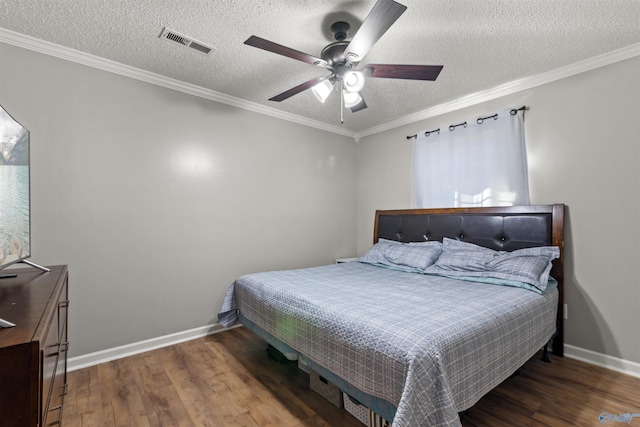 bedroom featuring hardwood / wood-style flooring, crown molding, and a textured ceiling