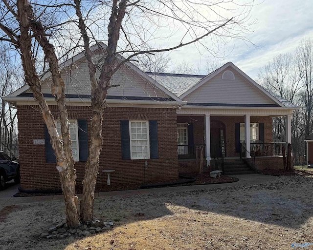 view of front of house with brick siding and a porch