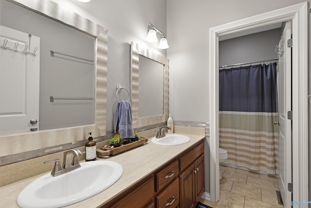 bathroom with a sink, curtained shower, toilet, and double vanity