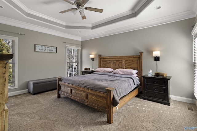 bedroom with a raised ceiling and multiple windows