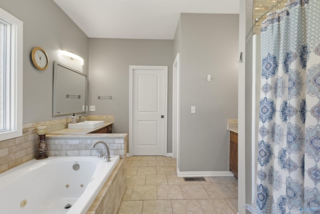 full bath with tile patterned flooring, a tub with jets, vanity, and a shower with curtain