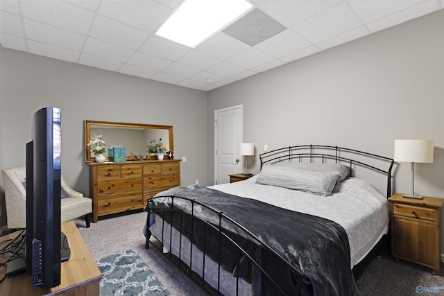 bedroom featuring carpet flooring and a drop ceiling
