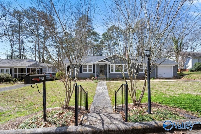 single story home with aphalt driveway, a garage, a fenced front yard, and a front lawn