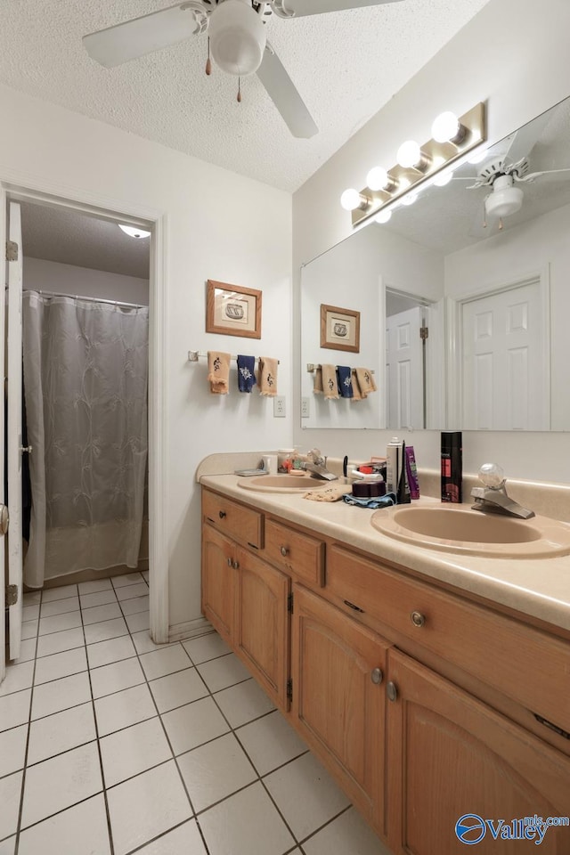 bathroom featuring a textured ceiling, ceiling fan, vanity, and tile patterned floors