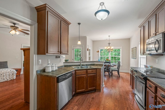 117 Somerset Park Dr NE, Huntsville, AL 35811 - kitchen with stainless steel appliances, a sink, dark countertops, and dark wood-style floors