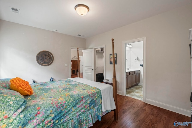 117 Somerset Park Dr NE, Huntsville, AL 35811 - bedroom featuring wood finished floors, baseboards, a sink, ensuite bathroom, and a spacious closet
