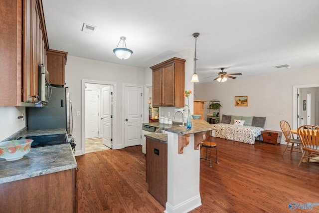 117 Somerset Park Dr NE, Huntsville, AL 35811 - kitchen with ceiling fan, a peninsula, a sink, range with electric cooktop, and brown cabinets