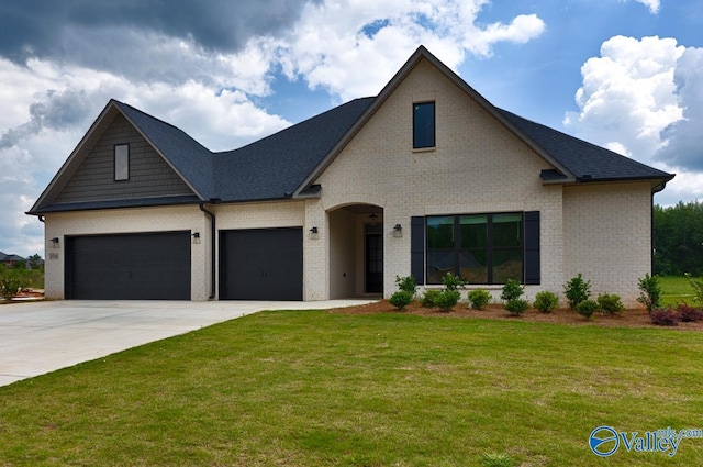 view of front of house featuring a garage and a front yard