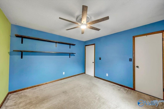 unfurnished bedroom with light colored carpet, a textured ceiling, ceiling fan, and a closet