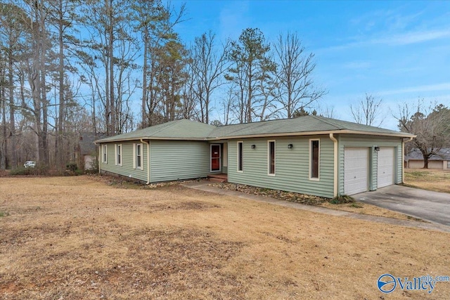 ranch-style home with a garage and a front lawn