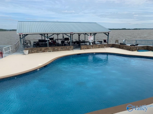 view of swimming pool with a gazebo, a patio area, and a water view