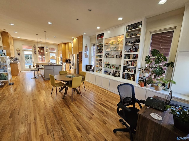 dining space with light wood-style floors and recessed lighting