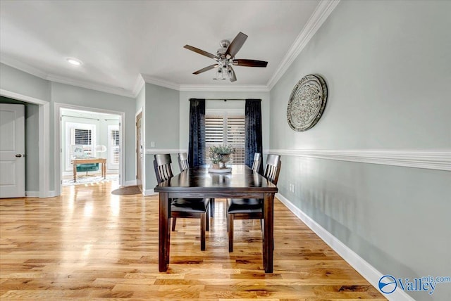 dining space featuring ceiling fan, ornamental molding, and light hardwood / wood-style floors