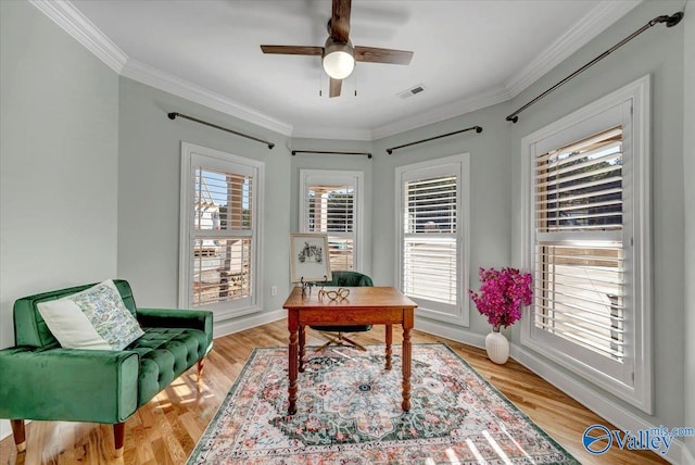 office space featuring ceiling fan, light hardwood / wood-style flooring, and ornamental molding