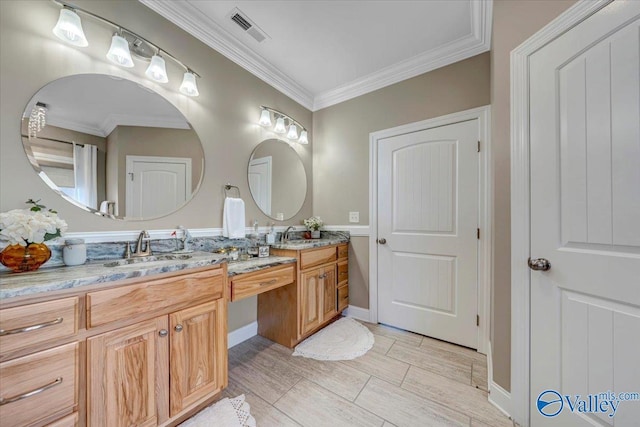 bathroom featuring vanity and ornamental molding