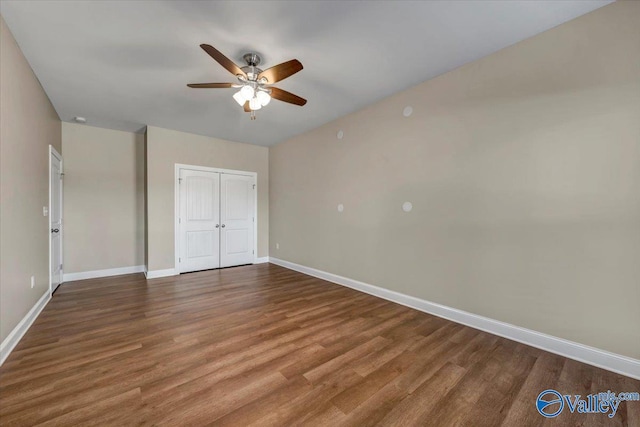 unfurnished bedroom with hardwood / wood-style flooring, a closet, and ceiling fan