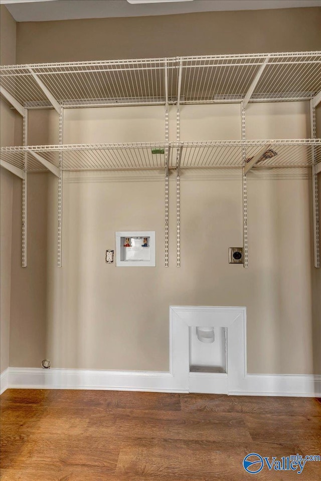 clothes washing area featuring washer hookup, wood-type flooring, gas dryer hookup, and hookup for an electric dryer