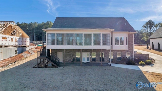 back of property featuring a sunroom