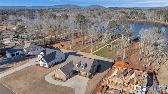 drone / aerial view featuring a water and mountain view