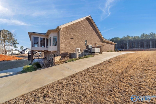 view of side of home featuring central AC unit