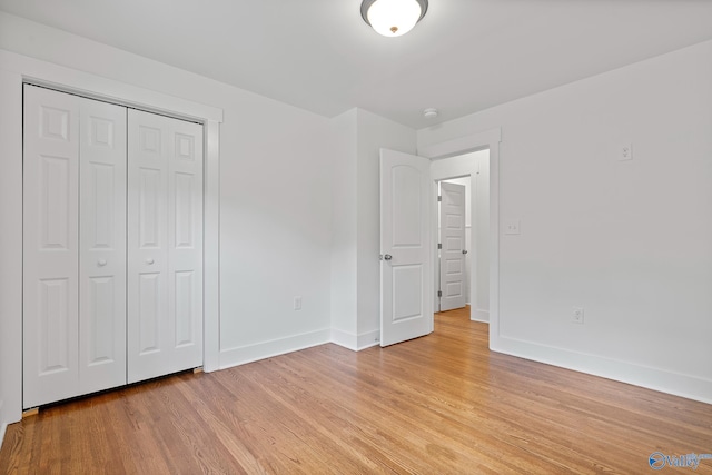 3631 NW Stag Run Dr, Huntsville, AL 35810 - unfurnished bedroom featuring baseboards, light wood-type flooring, and a closet
