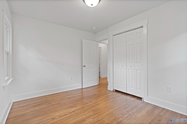 3631 NW Stag Run Dr, Huntsville, AL 35810 - unfurnished bedroom featuring light wood-style floors, a closet, and baseboards