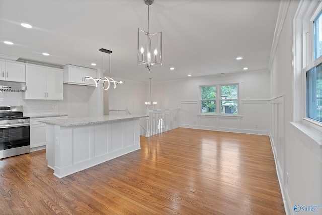 3631 NW Stag Run Dr, Huntsville, AL 35810 - kitchen featuring stainless steel range with electric stovetop, wall chimney range hood, a chandelier, light wood finished floors, and white cabinetry