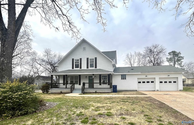 view of front of property with a front yard, covered porch, an attached garage, and concrete driveway