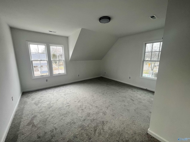 bonus room with carpet floors, a wealth of natural light, and visible vents