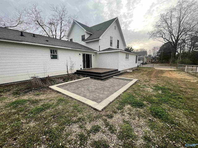 back of house featuring a patio, a lawn, fence, and a wooden deck